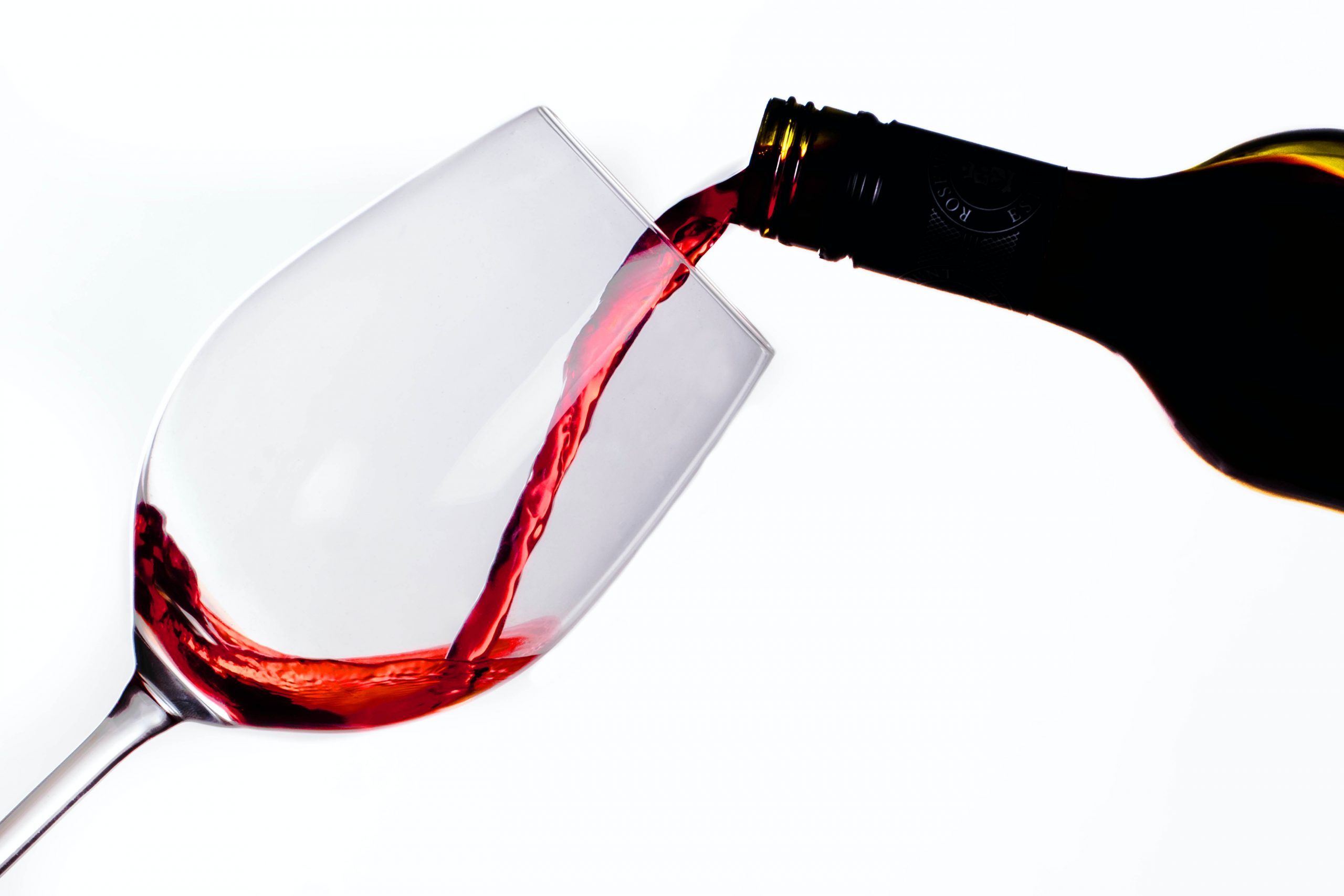 Person pouring red wine.